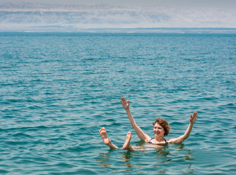 woman floating in the dead sea, jordan